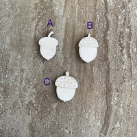 Handmade wood acorn cutouts in three DIY craft styles