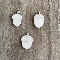 Handmade wood acorn cutouts in three DIY craft styles