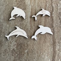 Handmade wood dolphin cutouts in four unique DIY craft styles
