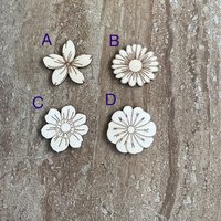 Handmade wood DIY flower cutouts in four different styles for crafts and painting projects