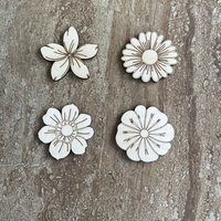 Handmade wood DIY flower cutouts in four different styles for crafts and painting projects