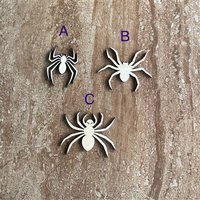 Handmade laser cut wood Halloween spider shapes in three different styles for DIY crafts