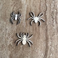 Handmade laser cut wood Halloween spider shapes in three different styles for DIY crafts