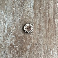 Handmade wooden sunflower buttons with detailed petals for craft projects
