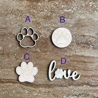 Handmade wooden DIY paw print cutout in four unique styles, ready to paint or decorate