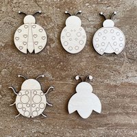 Handmade wooden DIY ladybug cutout in five unique styles, ready to paint or decorate