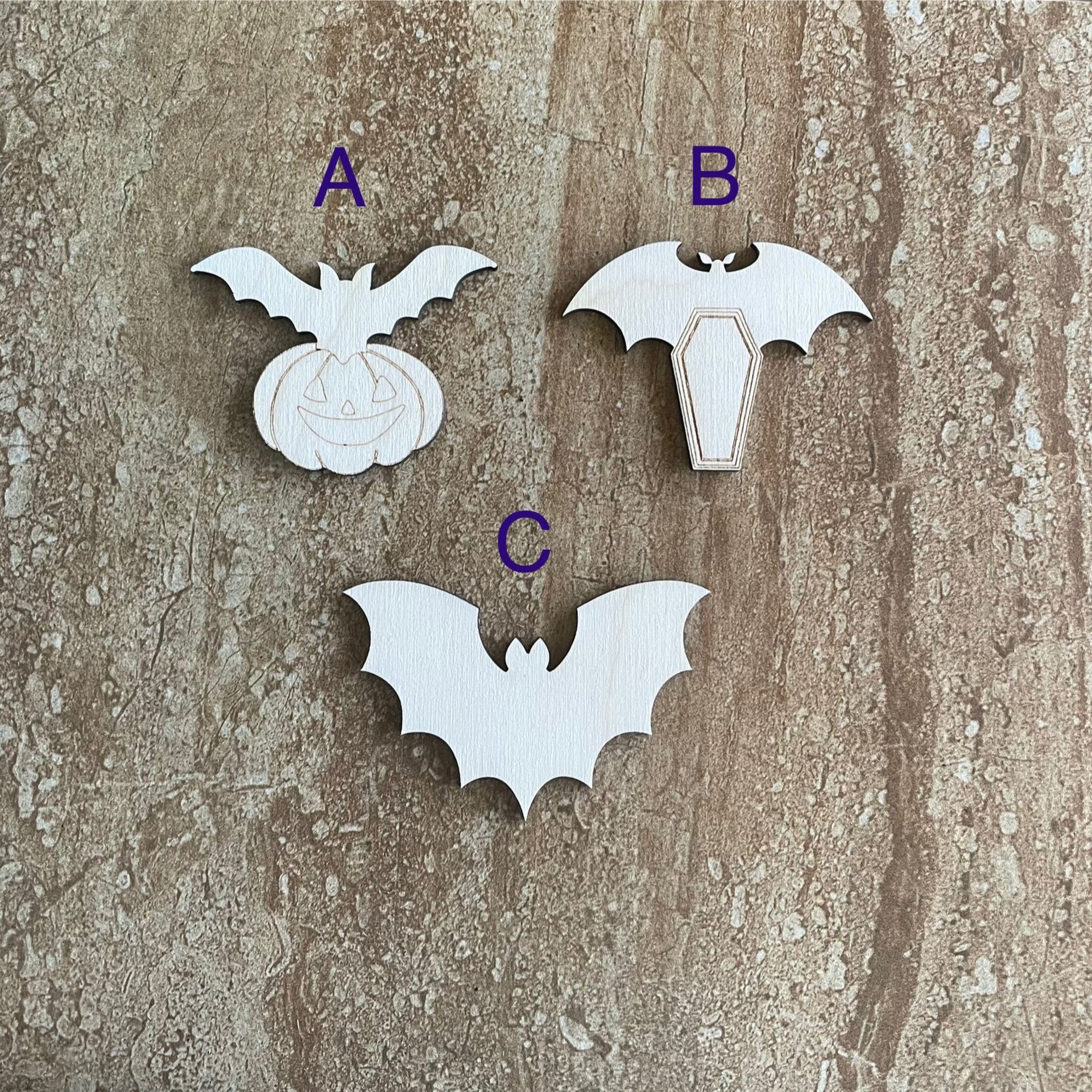 Handmade wood bat cutouts for Halloween crafts, available in three DIY styles