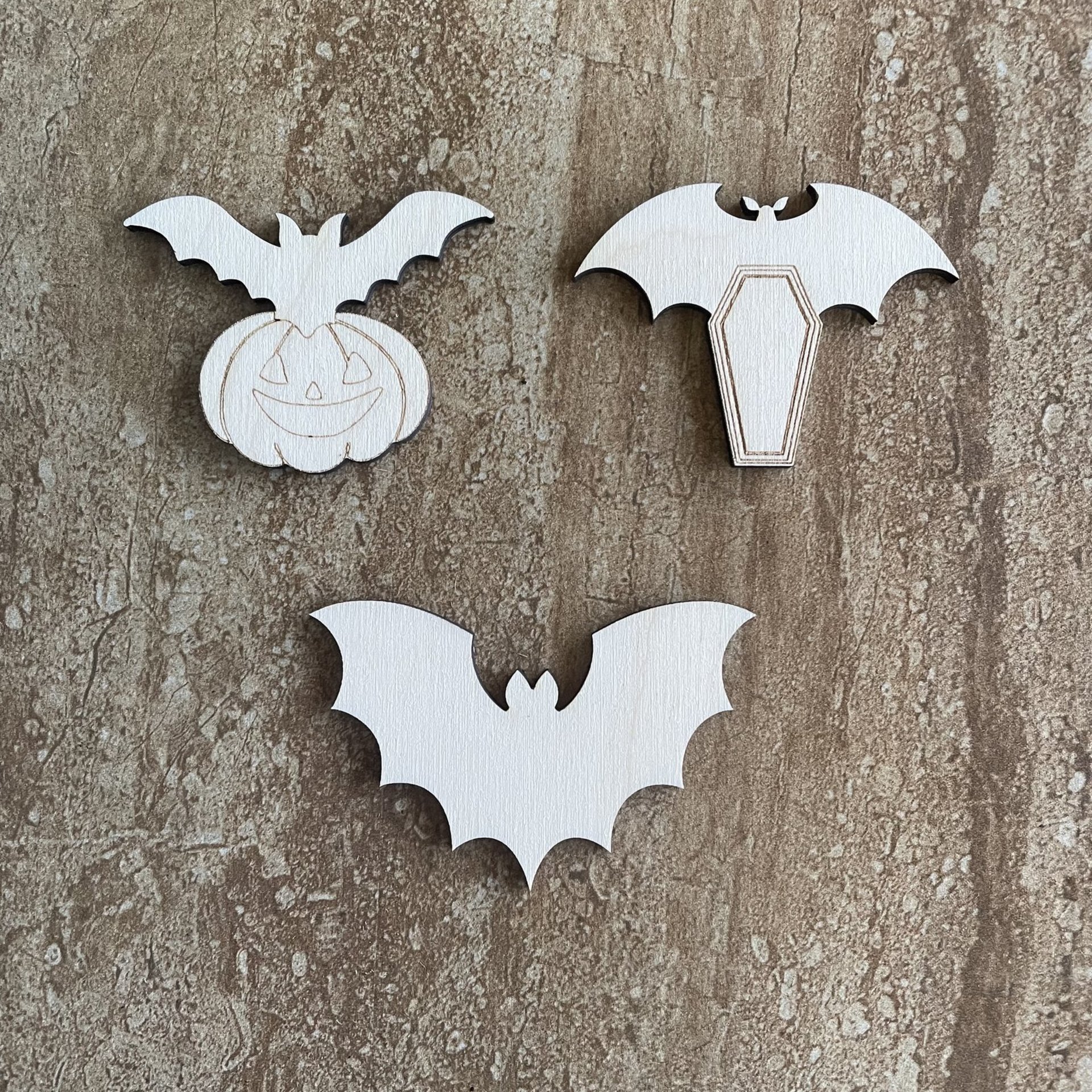 Handmade wood bat cutouts for Halloween crafts, available in three DIY styles