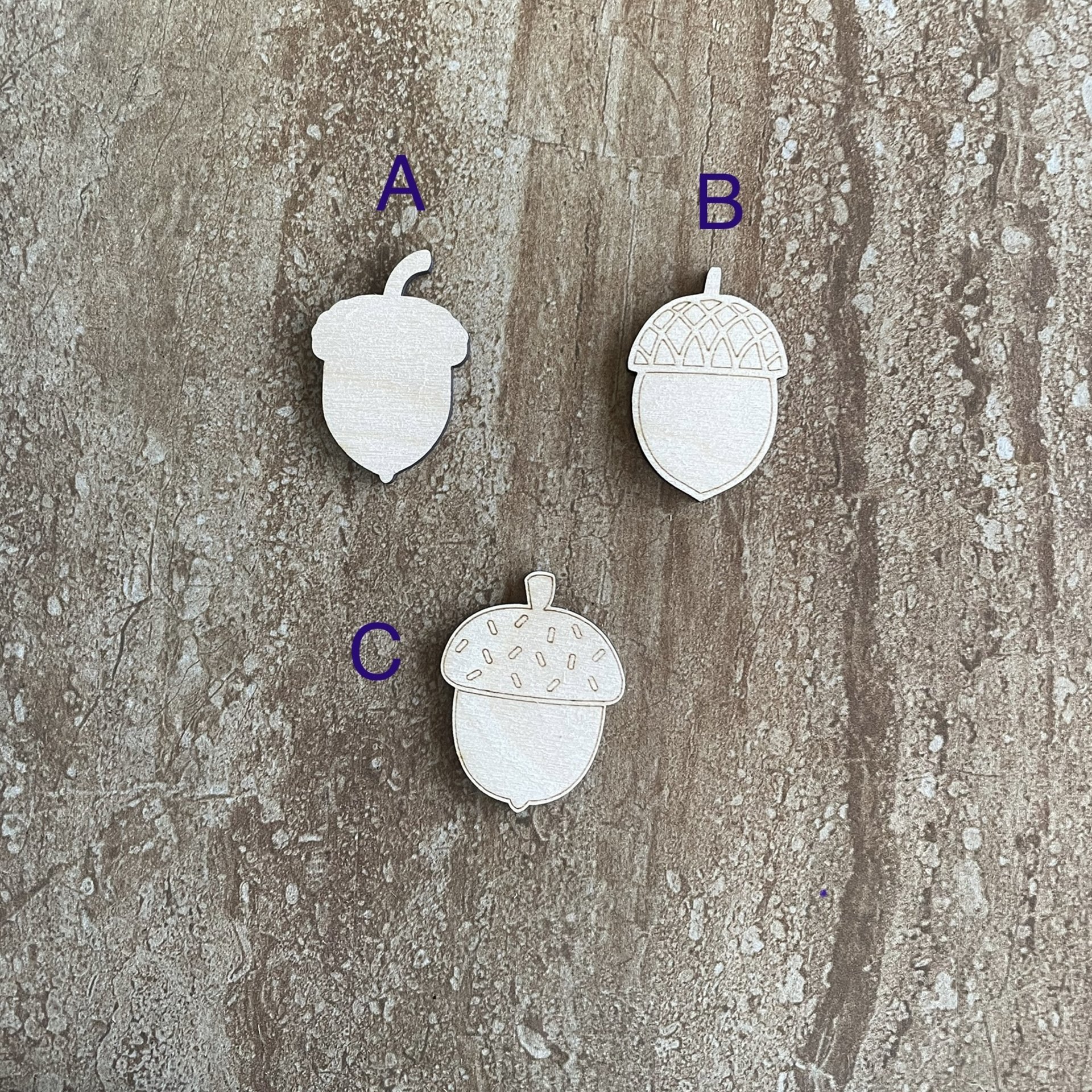 Handmade wood acorn cutouts in three DIY craft styles