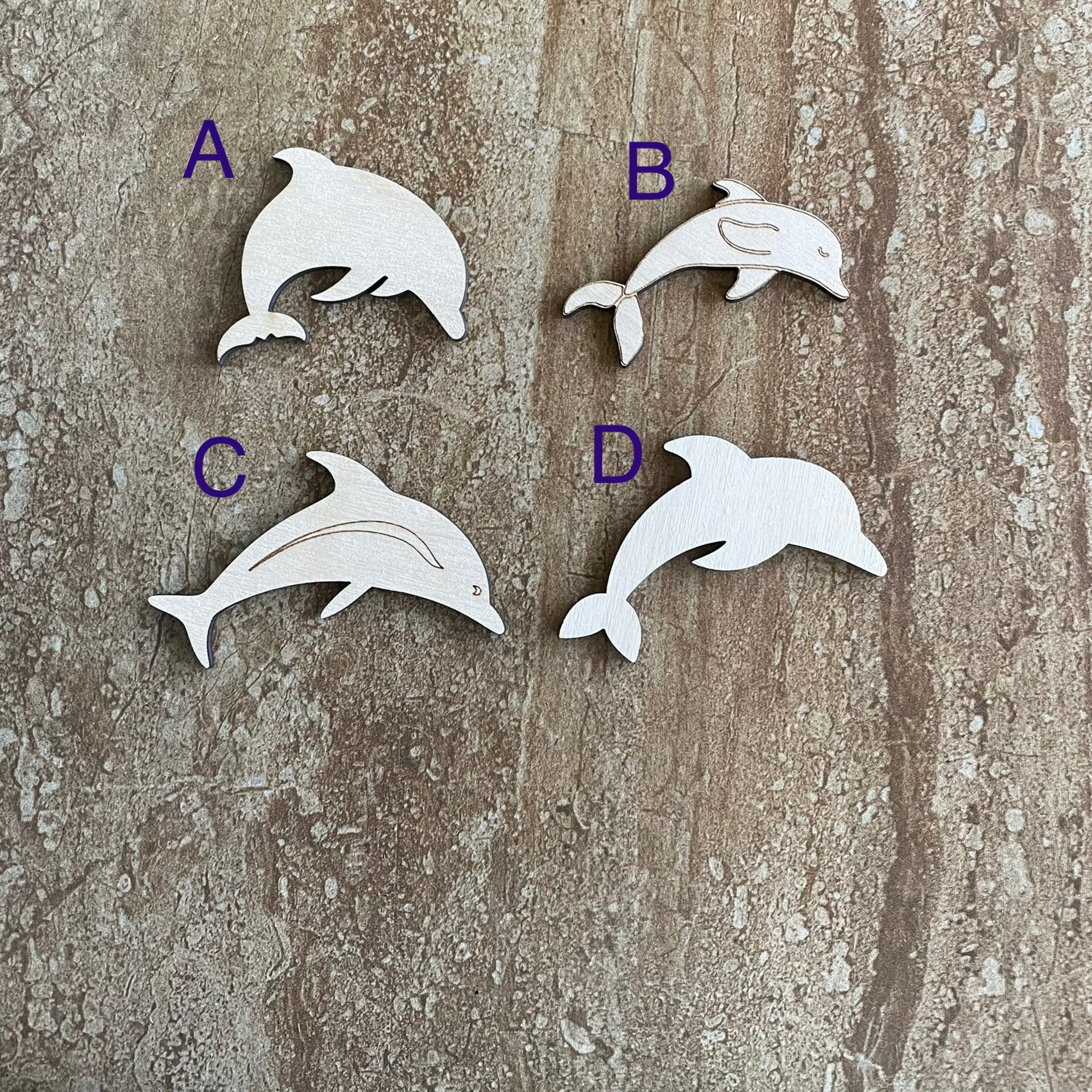 Handmade wood dolphin cutouts in four unique DIY craft styles