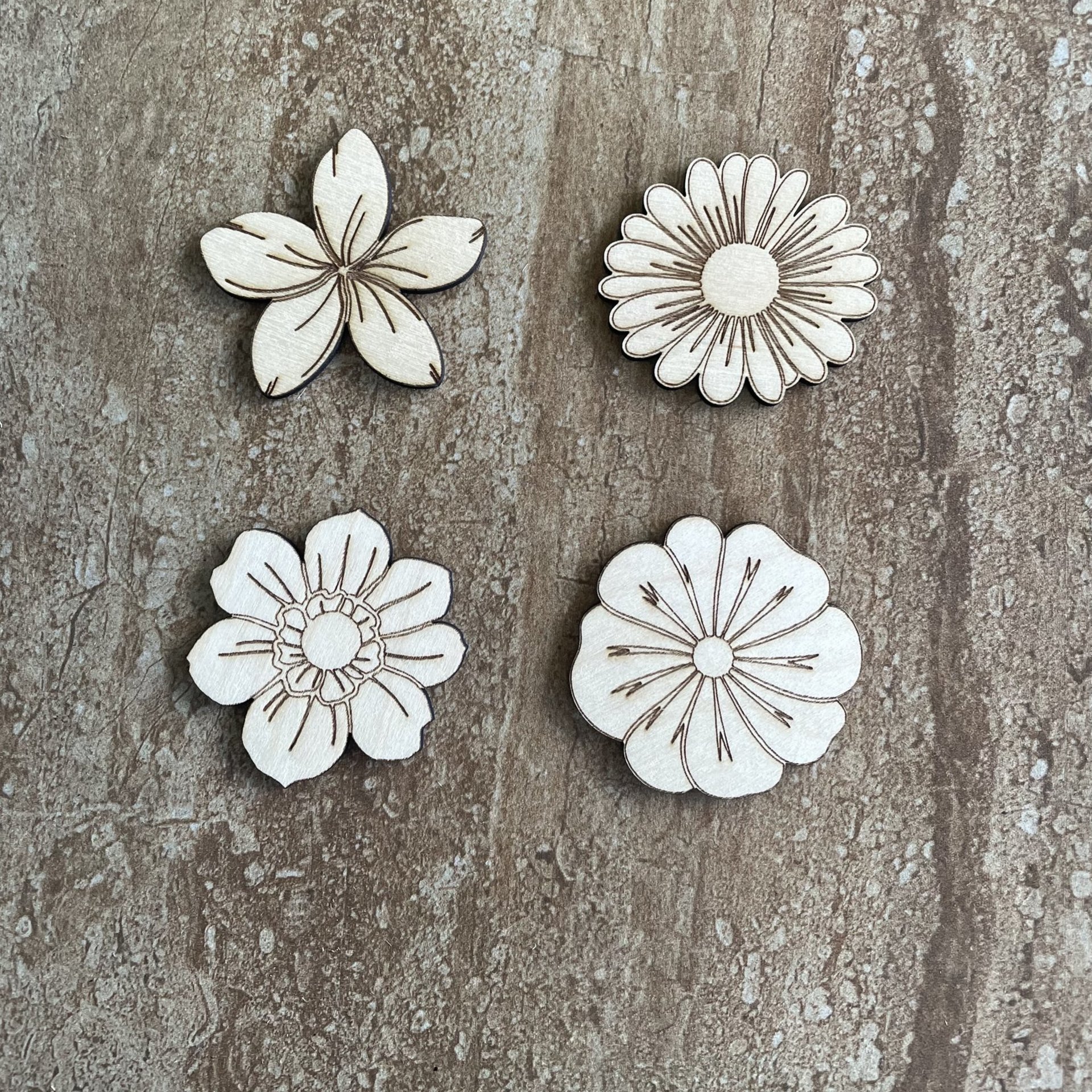 Handmade wood DIY flower cutouts in four different styles for crafts and painting projects