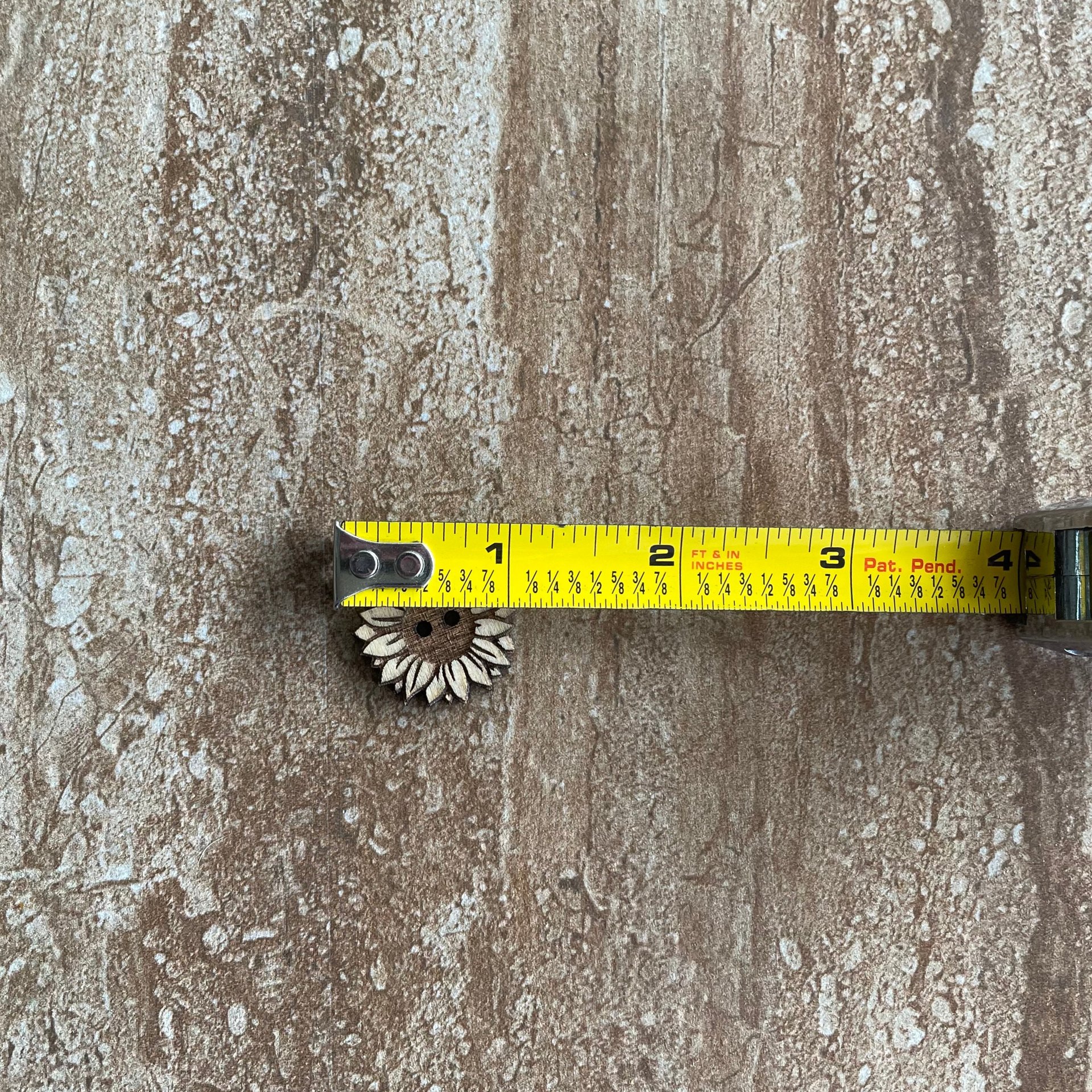 Handmade wooden sunflower buttons with detailed petals for craft projects