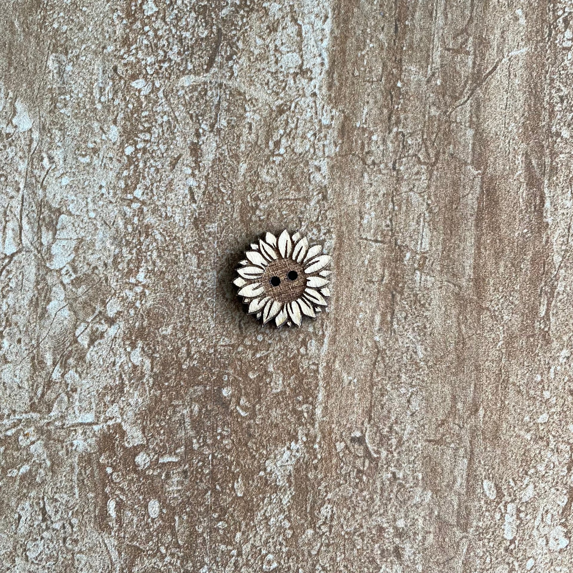 Handmade wooden sunflower buttons with detailed petals for craft projects