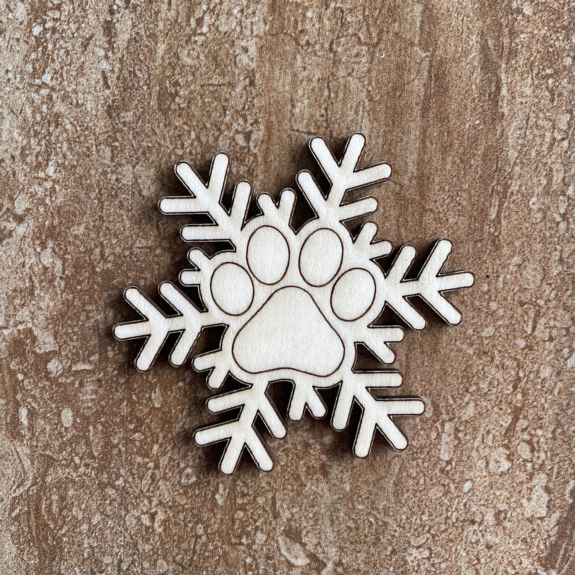 Handmade wooden DIY pawprint snowflake cutout ready for paint or decorating