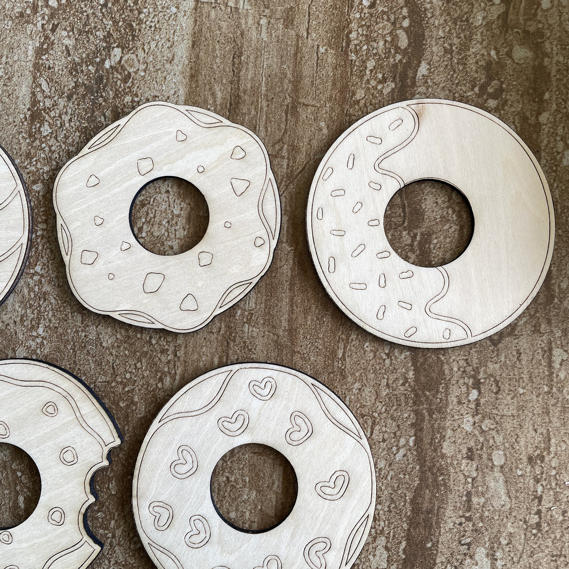 Handmade wooden DIY donut cutout in five unique styles, ready for paint or decorating