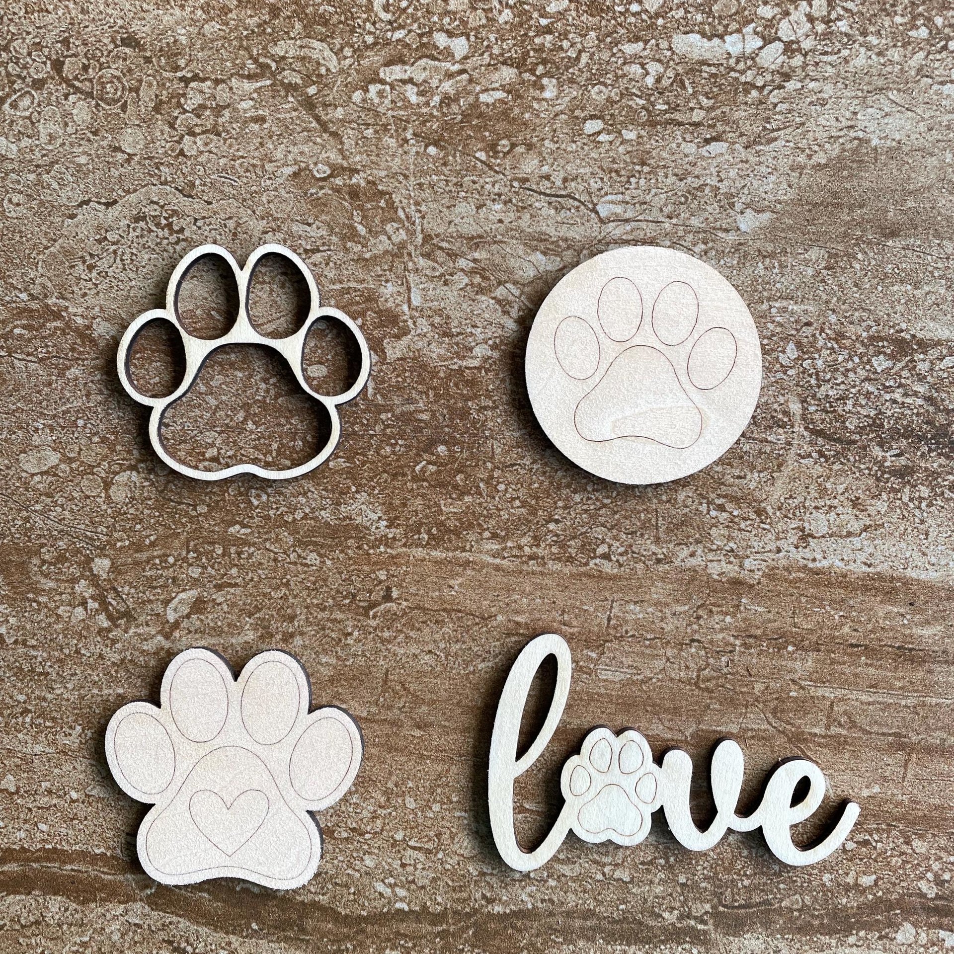 Handmade wooden DIY paw print cutout in four unique styles, ready to paint or decorate