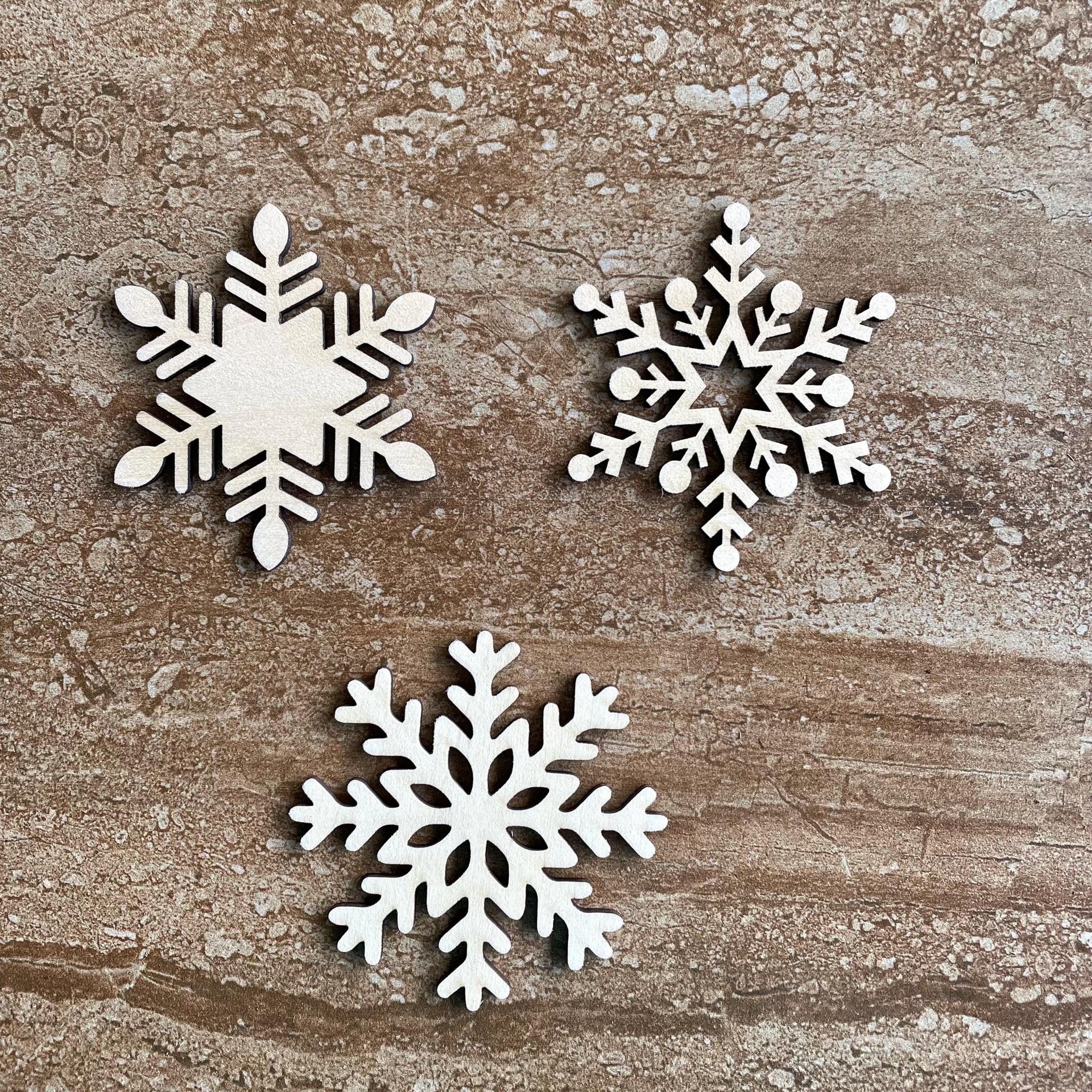 Handmade wooden DIY snowflake cutout in three unique styles, ready for paint or decorating