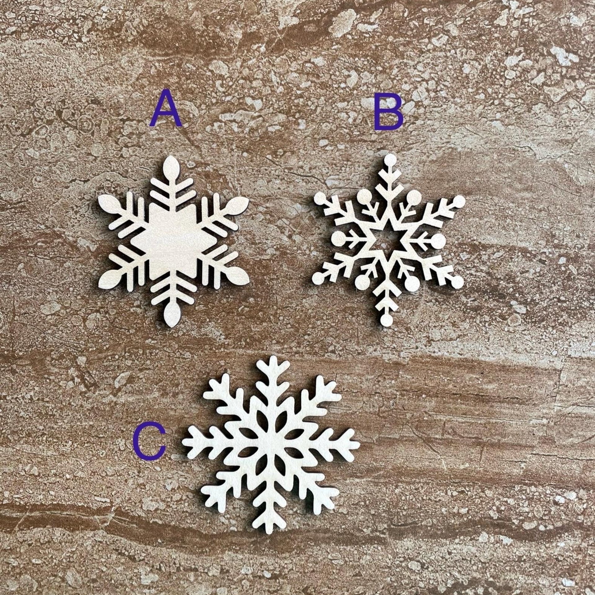 Handmade wooden DIY snowflake cutout in three unique styles, ready for paint or decorating