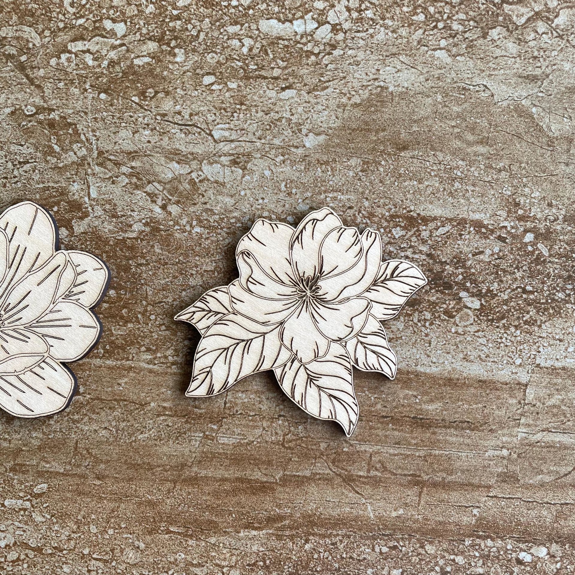 Handmade wooden DIY magnolia flower cutouts in two unique styles, ready for paint or decorating