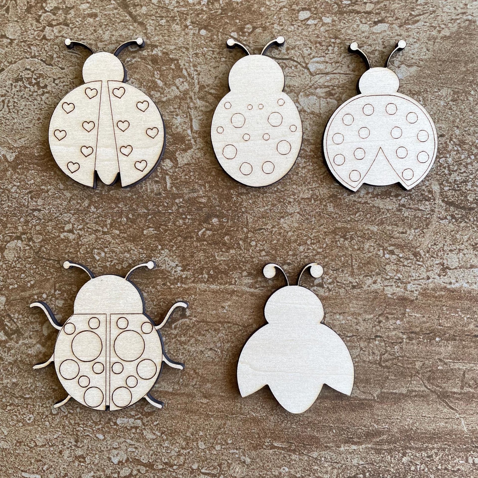 Handmade wooden DIY ladybug cutout in five unique styles, ready to paint or decorate