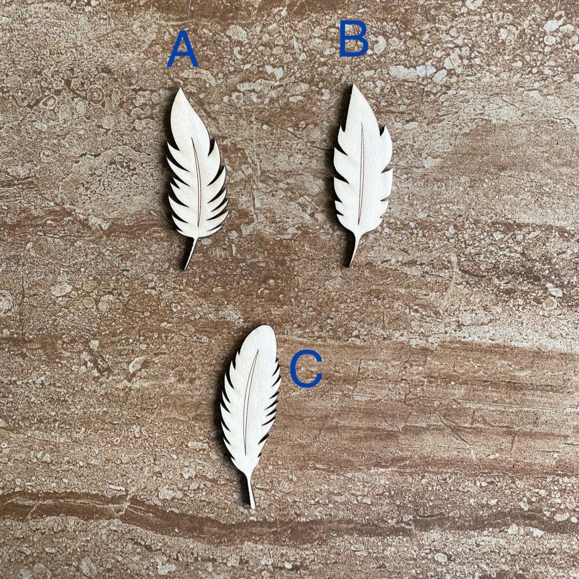 Handmade wooden DIY feather cutout in three unique styles, ready for paint or decorating
